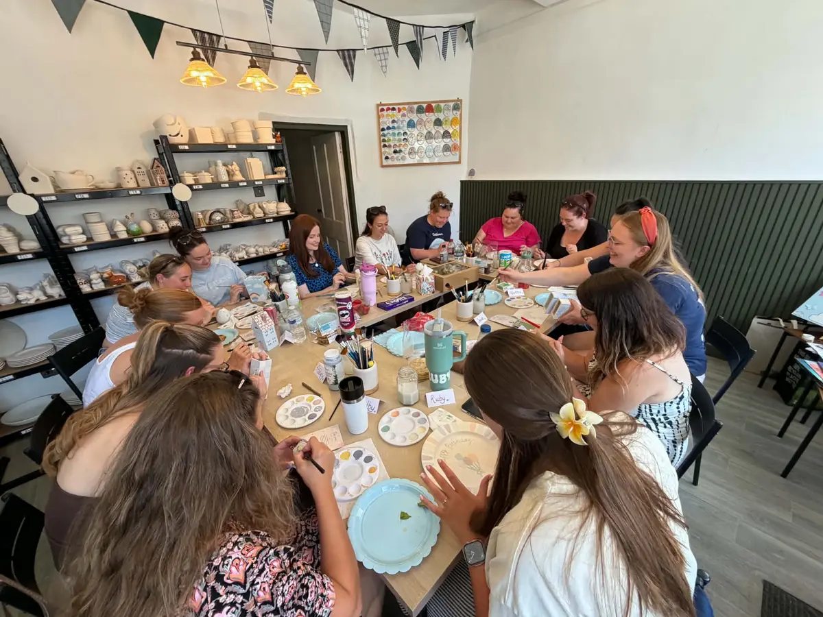 People taking part in a pottery-painting activity